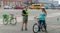 Learn to Ride. Student and instructor talk on training course.