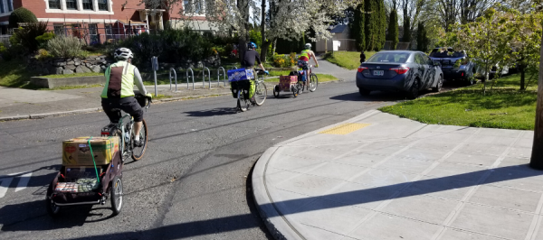 Cascade staff and volunteers deliver groceries by bike while staying 6 feet apart